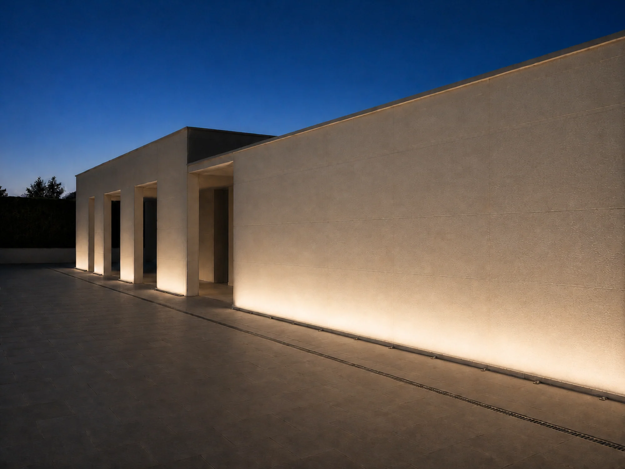 Warm linear wall washing along a modern exterior facade