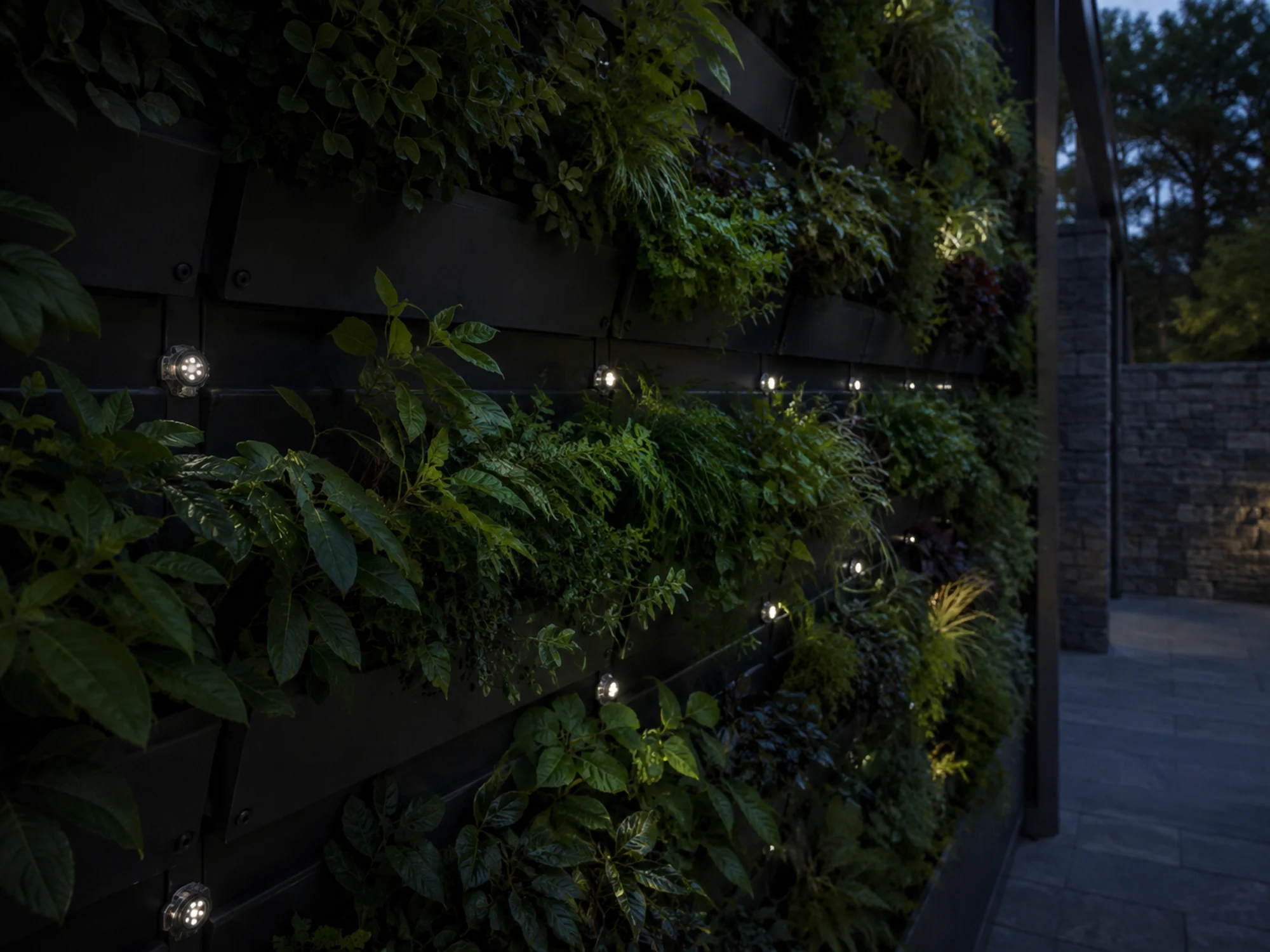 Compact pixel lights integrated into an exterior planted wall
