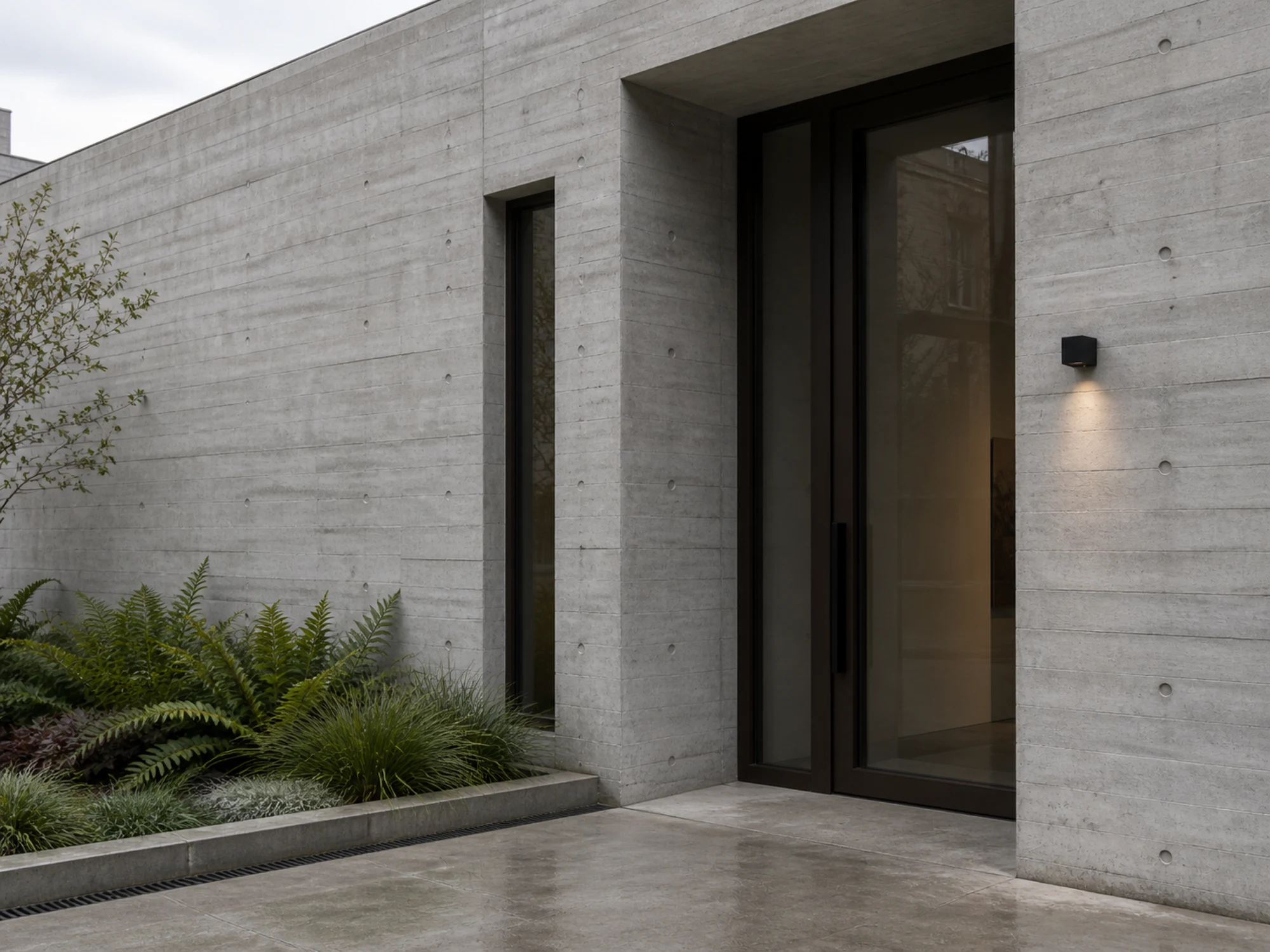 WL04 square wall light integrated into a concrete entrance facade
